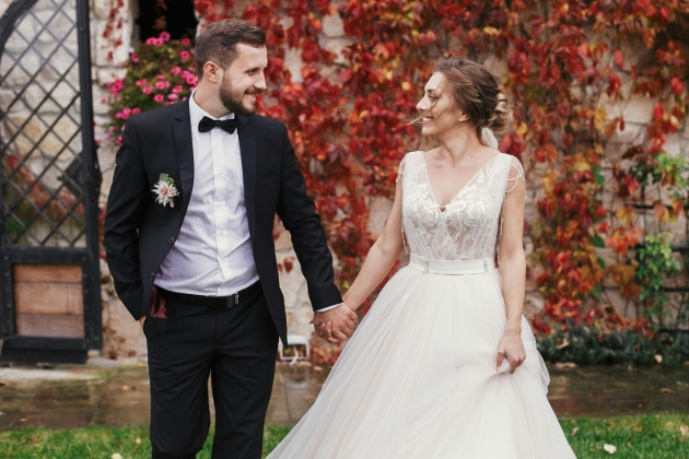 wedding couple holding hands outside wedding venue