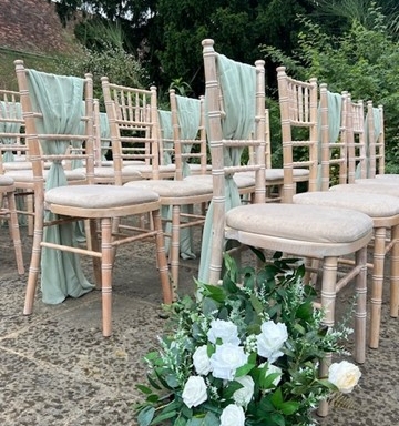 chivari chairs outside with mint green sashes